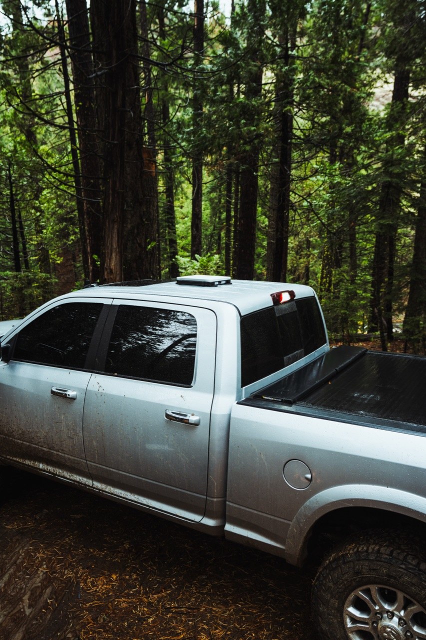 Pickup truck in the field with a Starlink Mini mounted on the roof
